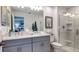 Elegant bathroom featuring double vanity sinks and glass-enclosed shower at 161 River Front Way, Edgewater, FL 32141