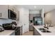 Modern kitchen featuring stainless appliances, gray cabinets, and white countertops at 161 River Front Way, Edgewater, FL 32141