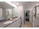 Bathroom featuring double vanity sinks, modern fixtures, and geometric wall accents at 2956 Penelope Loop, Kissimmee, FL 34746