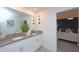 Modern bathroom featuring double sinks, vanity, and an ensuite bedroom at 2956 Penelope Loop, Kissimmee, FL 34746