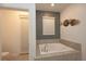 This bathroom features a soaking tub with tile surround and chrome fixtures at 2956 Penelope Loop, Kissimmee, FL 34746