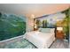 Themed bedroom with whimsical mural, plush queen bed, designer rug and stylish side tables at 2956 Penelope Loop, Kissimmee, FL 34746