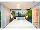 Themed bedroom with whimsical mural, plush queen bed, designer rug, and en suite bath at 2956 Penelope Loop, Kissimmee, FL 34746