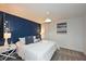 Stylish bedroom features a blue accent wall and coordinated décor at 2956 Penelope Loop, Kissimmee, FL 34746