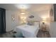 Bright bedroom with a plush bed, woven pendant light, and modern wall art at 2956 Penelope Loop, Kissimmee, FL 34746