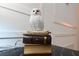Charming owl statuette sitting atop books on a black marble side table at 2956 Penelope Loop, Kissimmee, FL 34746