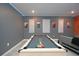 Basement game room featuring a pool table, modern lighting, and stylish decor at 2956 Penelope Loop, Kissimmee, FL 34746