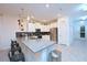 Bright, contemporary kitchen with white cabinetry, stainless steel appliances, a large island and stylish pendant lighting at 2956 Penelope Loop, Kissimmee, FL 34746