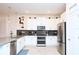 Modern kitchen with white cabinets, stainless steel appliances, gray countertops, and stylish decor accents at 2956 Penelope Loop, Kissimmee, FL 34746