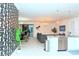 Open-concept kitchen and living room area with contemporary decor and stainless steel appliances at 2956 Penelope Loop, Kissimmee, FL 34746