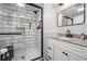 Bathroom boasts granite counters, white vanity, black hardware and a glass enclosed shower with black trim at 5006 Lodgewood Dr, Lakeland, FL 33810