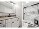 Bathroom boasts granite counters, white vanity, black hardware and a glass enclosed shower with black trim at 5006 Lodgewood Dr, Lakeland, FL 33810