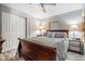Bedroom with wood bed, matching wood furniture, a ceiling fan and wood grain floors at 5006 Lodgewood Dr, Lakeland, FL 33810