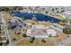 Aerial view of the community's recreation center, tennis court, and pond with fountain at 5006 Lodgewood Dr, Lakeland, FL 33810