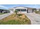 Charming home features a well-kept lawn, a driveway, and an attached garage for parking and convenience at 5006 Lodgewood Dr, Lakeland, FL 33810