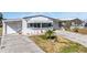 Charming home features a well-kept lawn, a driveway, and an attached garage for parking and convenience at 5006 Lodgewood Dr, Lakeland, FL 33810