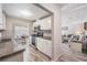 Bright kitchen with stainless steel appliances and white cabinets overlooks a dining area and a living room at 5006 Lodgewood Dr, Lakeland, FL 33810