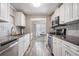 Bright kitchen with stainless steel appliances, granite counters and white cabinets overlooks a dining area at 5006 Lodgewood Dr, Lakeland, FL 33810