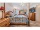 Bedroom with wood four poster bed, matching wood furniture, a ceiling fan and wood grain floors at 5006 Lodgewood Dr, Lakeland, FL 33810