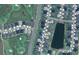 Aerial view of homes near a golf course and pond, showcasing the community layout at 6922 Wendy Way, The Villages, FL 34762