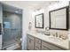 Bathroom showcasing double sinks, modern fixtures, framed mirrors, and a glass door shower at 6922 Wendy Way, The Villages, FL 34762
