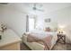 Bedroom with a ceiling fan, natural lighting, neutral tones, and ample space at 6922 Wendy Way, The Villages, FL 34762