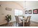 Charming dining room with modern chandelier, large window, and seating for six at 6922 Wendy Way, The Villages, FL 34762