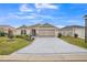 Inviting single-story home featuring well manicured front lawn and a patterned concrete driveway at 6922 Wendy Way, The Villages, FL 34762