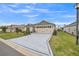 Inviting home featuring a decorative driveway, manicured lawn, and beautiful landscaping under a bright blue sky at 6922 Wendy Way, The Villages, FL 34762