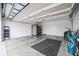 Spacious garage featuring ample storage, overhead racks, and clean epoxy flooring perfect for organization at 6922 Wendy Way, The Villages, FL 34762