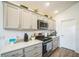 Stylish kitchen featuring stainless steel appliances and plenty of counter space at 6922 Wendy Way, The Villages, FL 34762