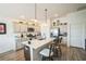 Open kitchen with a large island, stainless steel appliances, and a breakfast bar at 6922 Wendy Way, The Villages, FL 34762