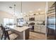 Bright kitchen with stainless steel appliances and a center island with breakfast bar seating at 6922 Wendy Way, The Villages, FL 34762