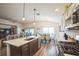 Bright kitchen with stainless steel appliances and center island adjacent to dining area at 6922 Wendy Way, The Villages, FL 34762