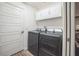 Laundry room featuring side-by-side washer and dryer, ample storage, and a convenient layout at 6922 Wendy Way, The Villages, FL 34762