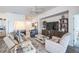 Cozy living room with comfortable seating, a large TV, stylish decor, and plenty of natural light at 6922 Wendy Way, The Villages, FL 34762