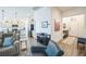 Open-concept living area with a kitchen view, wine rack, and seamless transition from one space to another at 6922 Wendy Way, The Villages, FL 34762