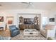 Cozy living room features a modern entertainment center and stylish seating arrangement at 6922 Wendy Way, The Villages, FL 34762
