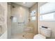 This walk-in shower is tiled and contains a glass door, grab bar, and shower seat at 6922 Wendy Way, The Villages, FL 34762