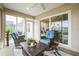 Relaxing sunroom offering wicker furniture, bright cushions, sliding doors, and scenic outdoor views at 6922 Wendy Way, The Villages, FL 34762