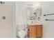 Bathroom featuring a shower, toilet and vanity with lighting above the mirror at 6087 Sunset Vista Dr, Lakeland, FL 33812