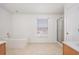 Bathroom featuring a soaking tub, tiled floors, and a glass-enclosed shower at 6087 Sunset Vista Dr, Lakeland, FL 33812