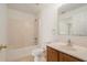 Bathroom with shower, toilet, vanity and mirror with wooden cabinets at 6087 Sunset Vista Dr, Lakeland, FL 33812
