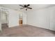 Bedroom featuring a doorway to the bathroom, neutral colored walls and carpet at 6087 Sunset Vista Dr, Lakeland, FL 33812