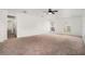 Spacious bedroom with neutral carpet, ceiling fan, and arched windows at 6087 Sunset Vista Dr, Lakeland, FL 33812