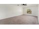 Spacious bedroom with neutral carpet, bright window views, and ceiling fan at 6087 Sunset Vista Dr, Lakeland, FL 33812