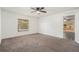 Bright bedroom offers comfortable carpeting and a window overlooking the outdoor pool area at 6087 Sunset Vista Dr, Lakeland, FL 33812