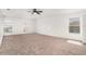 Expansive bedroom featuring neutral carpet, ceiling fan, and arched windows at 6087 Sunset Vista Dr, Lakeland, FL 33812