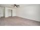 Bedroom featuring a closet, neutral colored walls and carpet, and ceiling fan at 6087 Sunset Vista Dr, Lakeland, FL 33812