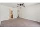 Bedroom featuring doorway to a bathroom, neutral colored walls and carpet at 6087 Sunset Vista Dr, Lakeland, FL 33812